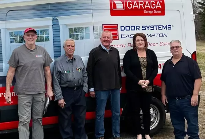 Door Systems Easthampton technicians in front of a truck services